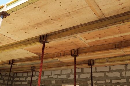 view of the wooden formwork with metal holders, which will be filled with construction of ceiling...