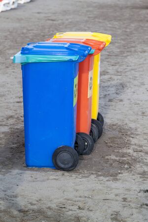 Three colorful recycle bins on the beachの写真素材
