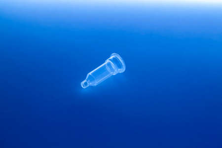 Plastic medical column for test tube stay alone on the blue backgroundの写真素材