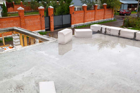view of the hardened concrete slab base between floors. Construction of a country house made of foam...