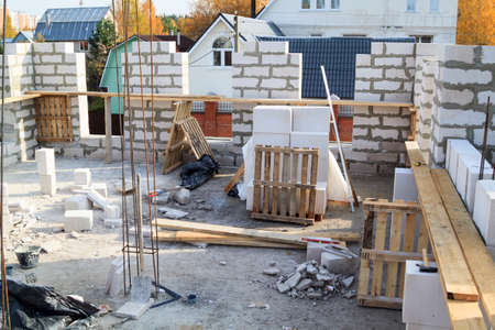 view of laying walls of first floor, fittings for filling supporting columns. Construction of...
