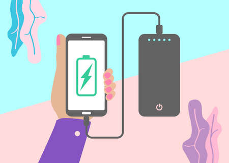 flat lay modern minimal hand holding mobile phone charging from portable battery or powerbank