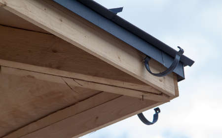 close up view of house under construction with holders for gutters water drainage system of roof