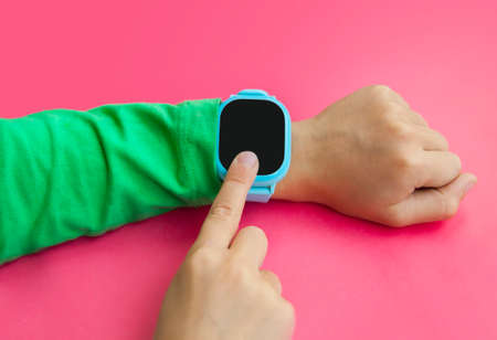 Wearable kids smart watch for calls and location tracking with touch screen and voice service, blue electronic gadget with rubber wristband for childrenの写真素材