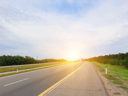 empty rural road lit by sunlight