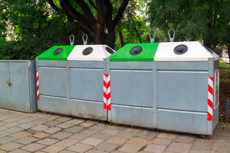 waste separation concept. Different Colored bins for collection of recycle materials near park....
