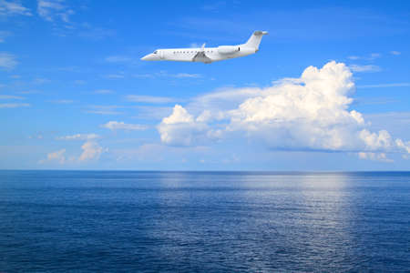 beautiful white clouds on blue sky over calm seaの写真素材