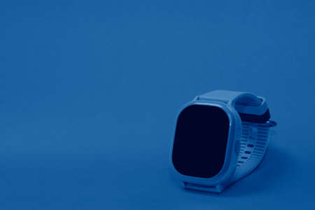 flat lay image of kids smart watch on pastel orange backgroundの写真素材