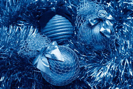 blue christmas balls on a golden tinselの写真素材