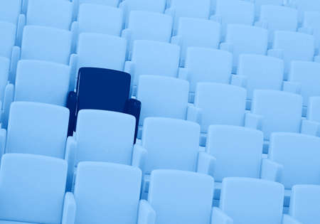 3D rendering of auditorium with one reserved seat toned in trendy Classic Blue color of the Year...