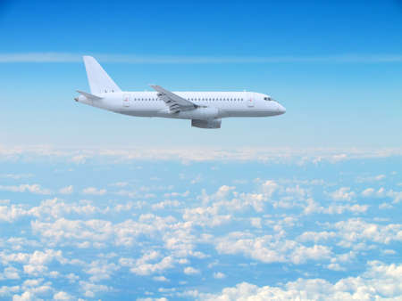 large white passenger plane flies high above the clouds