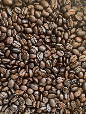 Close-up of freshly roasted coffee beans The fragrance is seductive, refreshing, and dark brown. It can be used to assemble print media, advertisements, print packages of the cafe.の写真素材