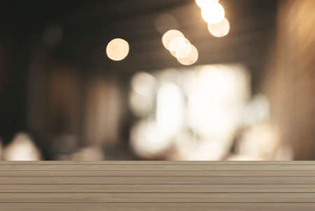 The surface on the empty wooden table and the blur background of the kitchen in the cafe. Can be...