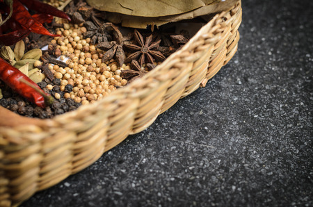 closeup herbs in a wicker basket Dare Black on the cement floor.の写真素材