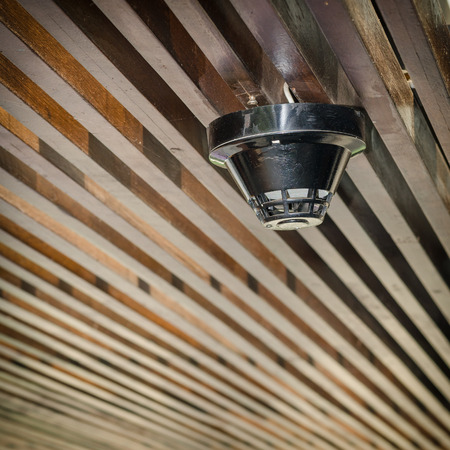 Wood Smoke detector mounted on ceilingの写真素材