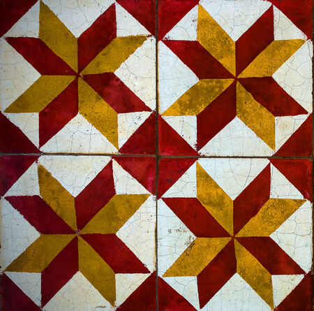 old beautiful traditional tiles with red and green star patterns.
