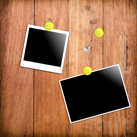 polaroid photo frames on wooden wall backgroundの写真素材