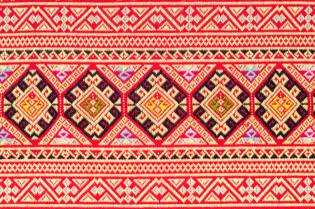 Fragment of colorful retro tapestry text, Fragment of colorful retro tapestry pattern with floral ornament useful as backgroundの写真素材