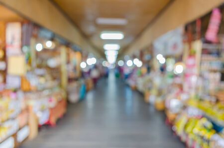 Blurred background : people shopping at market fair in sunny day, blur background with bokehの写真素材