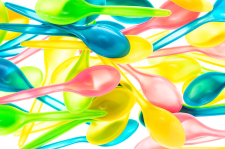 Colorful plastic ice cream spoons on a white background.の写真素材
