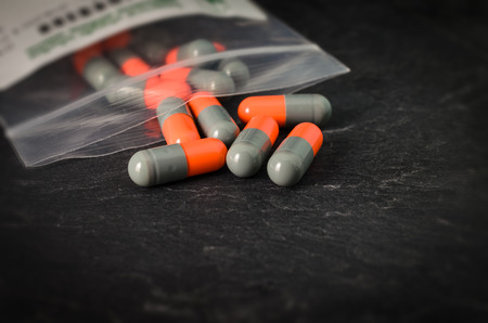 pharmaceutical drug brothel on a background of black stone.の写真素材