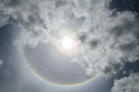 A full rainbow against blue skyの写真素材