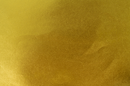 Gold paper texture or Shiny yellow leaf gold foil texture backgroundの写真素材