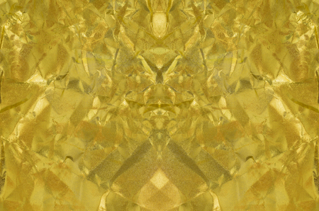 Gold paper texture or Shiny yellow leaf gold foil texture backgroundの写真素材