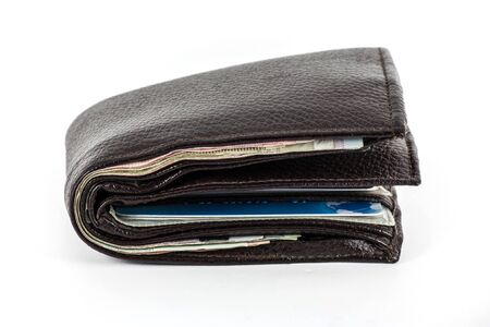 Canvas money bag on top of loose bills