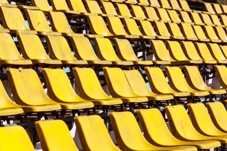 Rows of red football stadium seats with numbersの写真素材