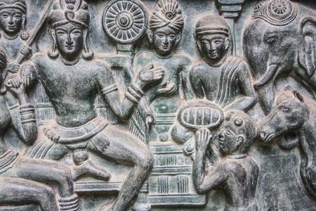 buddha statue on wall in thailandの写真素材