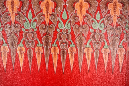 A very old Thai Buddhist temple mural painted in red and gold,の写真素材