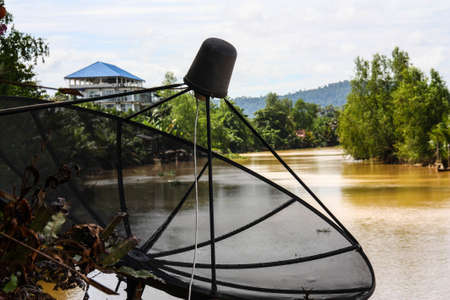 Satellite dish antenna on blue sky with cloudの写真素材