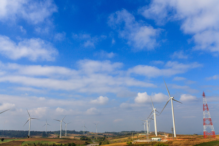 Wind turbines generate electricity in the mountains and the sky.