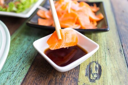 Sashimi Salmon chopsticks dipping sauceの写真素材