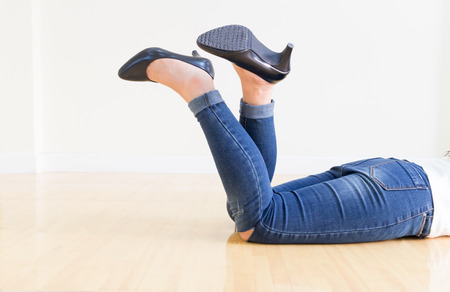 Young office Woman blue jeans Wearing High-heeled shoes ,sitting cross-legged On a white backgroundの写真素材