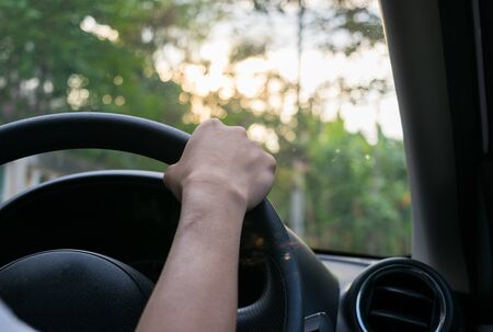 Woman driving car Sunlightの写真素材