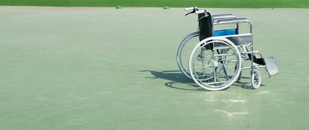 wheelchair the background is a buildingの写真素材