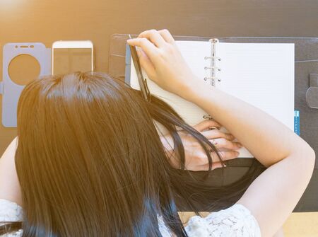 Woman lying head down on the desk,Work stressの写真素材