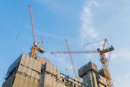 Building construction cranes and Skyscraper construction Many Cranesの写真素材
