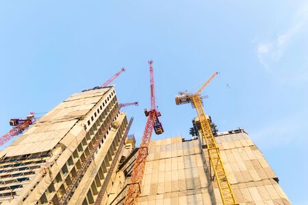 Building construction cranes and Skyscraper construction Many Cranesの写真素材