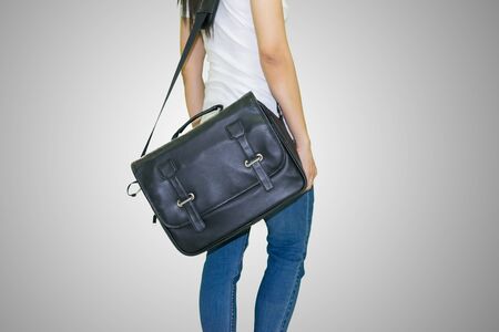Women wearing jeans standing Black leather handbagの写真素材