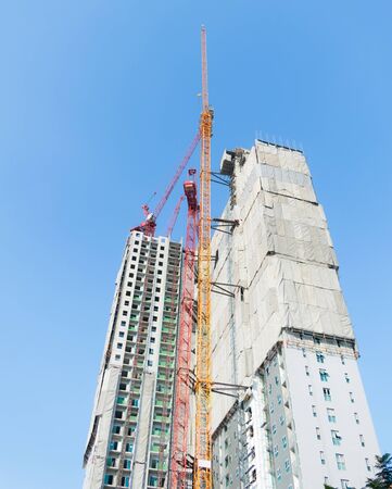 Building construction cranes and Skyscraper construction Many Cranesの写真素材