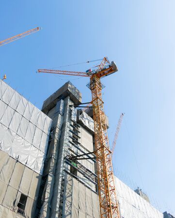 Building construction cranes and Skyscraper construction Many Cranesの写真素材