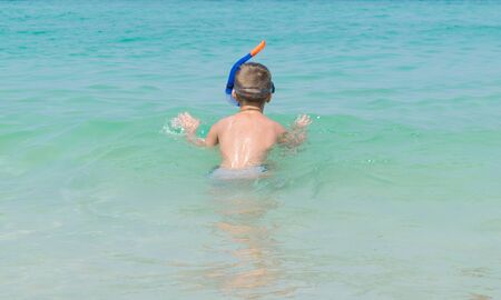 The boy put Snorkeling Dive into the seaの写真素材