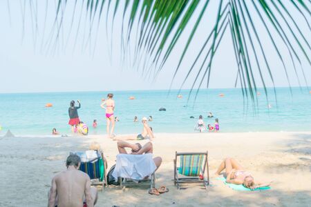 person sitting on the seat, sunbathing on the beach in Chonburi, Thailand.のeditorial素材