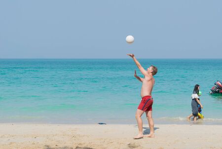 Chonburi Sai Kaew Beach people relaxing by the ocean and beach activities such as volleyball.の写真素材