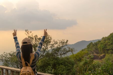 Woman travel hands two fingers Natural backgroundの写真素材