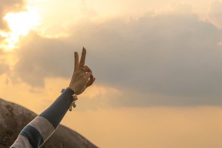 Woman travel hands two fingers Natural backgroundの写真素材
