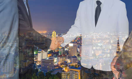 Partners shaking hands businessman shaking hands to seal a deal with his partner,Double Exposureの写真素材